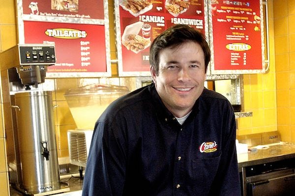 Todd Graves, founder of Raising Canes, poses for a photo inside the restaurant