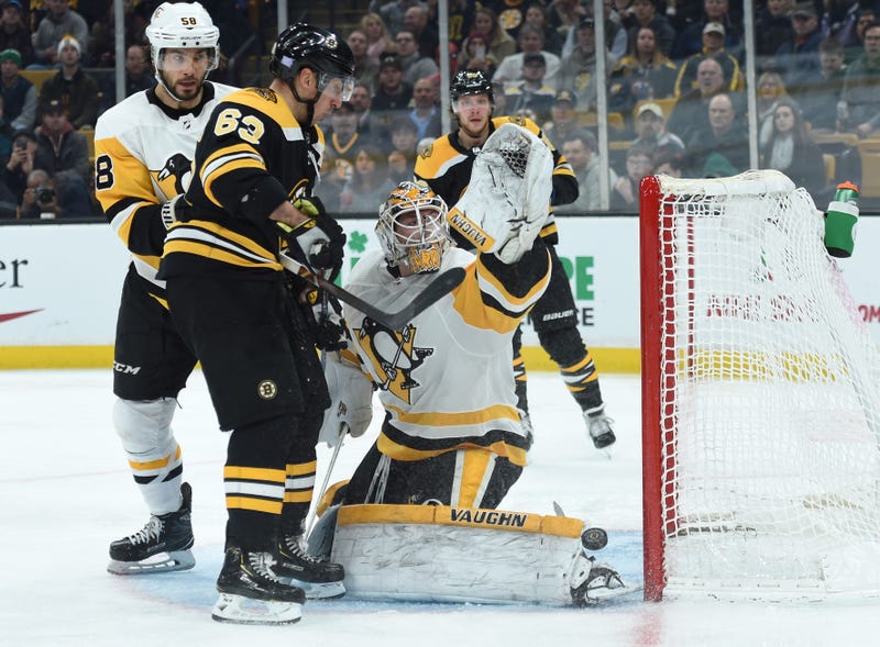 Brad Marchand in face of Tristan Jarry