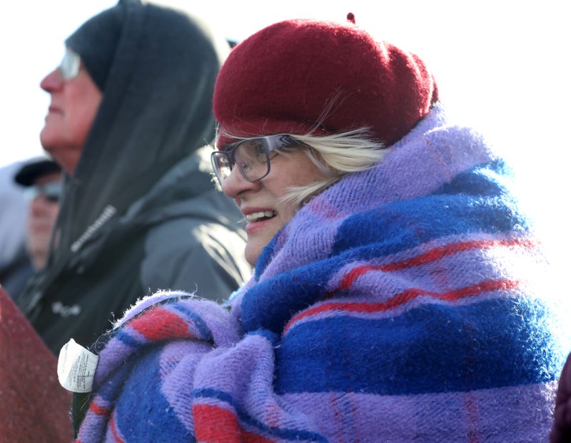 woman waits in the cold