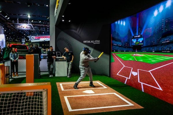 People swing away in a baseball simulation called the Virtual All-Star VR Experience