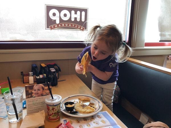 Three-year-old Naomi Bakker of Reno hoists a pancake mouthward at IHOP in South Reno