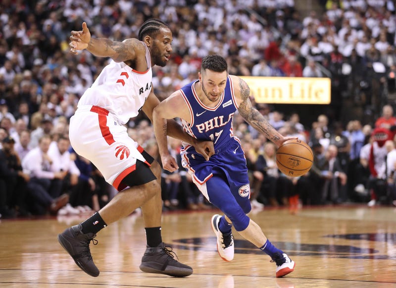 In game two of the second round of the 2019 NBA Playoffs, Philadelphia 76ers guard JJ Redick dribbles the ball past Toronto Raptors forward Kawhi Leonard.