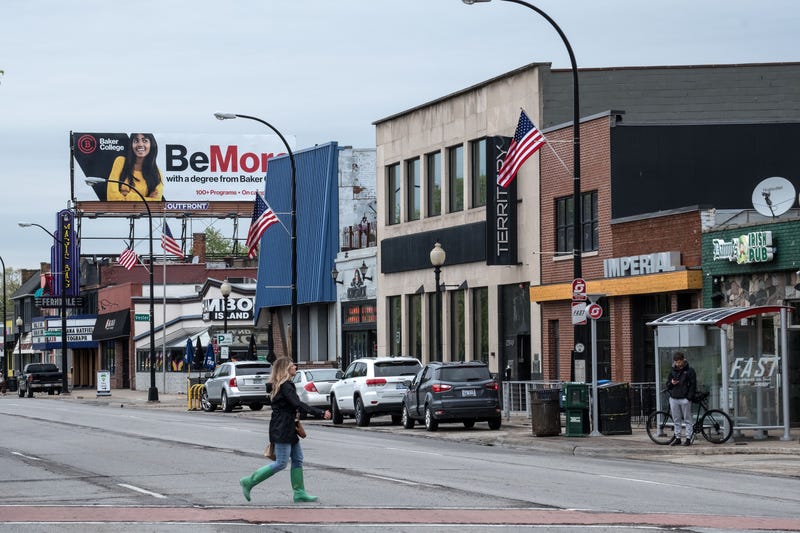 Woman walks across Woodward Avenue in Ferndale