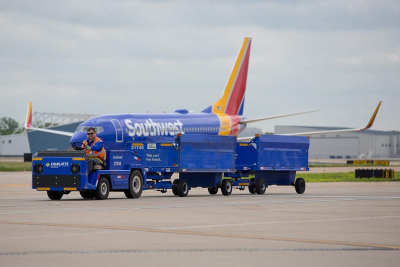 A baggage cart trundles across the ramp at Dallas Love Field on April 29, 2019.