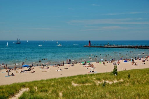 A Metro Detroit man is among two people who died after being pulled unresponsive from the waters of Lake Michigan on Monday, authorities confirmed.