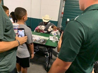 Michigan State cornerback Josh Butler with his dogs Remi and Roxy on Aug. 19, 2019 at Spartan Stadium.