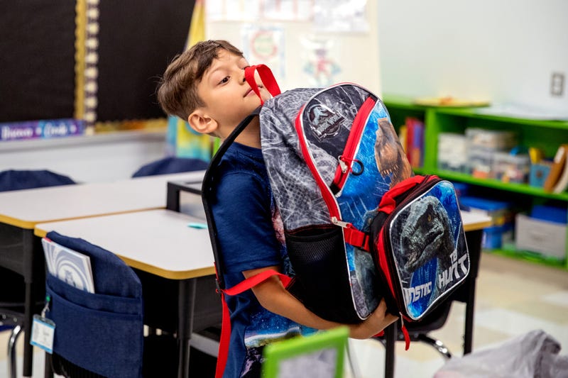 Maddox Jerden, 7, juggles a heavy backpack in his class at Windsor Park Elementary School