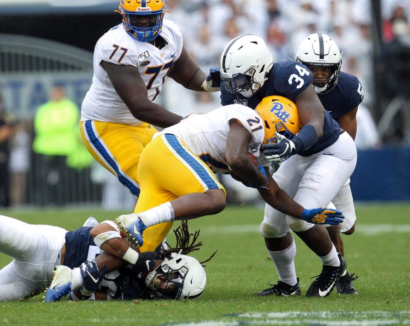 ; Penn State Nittany Lions safety Jonathan Sutherland (26) and defensive end Shane Simmons (34) tackle Pittsburgh Panthers running back A.J. Davis (21)