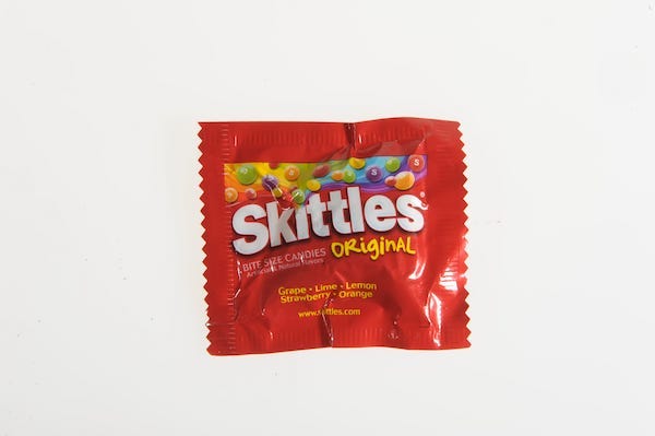 Bag of skittles isolated against white background