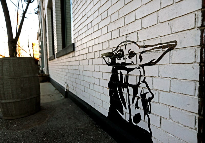 Artist Michael Cerda painted a baby Yoda onto Hotel Madrid in Walker's Point.