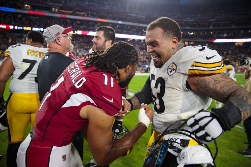 Larry Fitzgerald and Maurkice Pouncey embrace