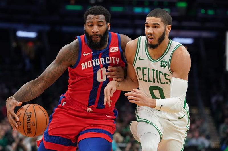 Andre Drummond drives past Jayson Tatum while on the Pistons.