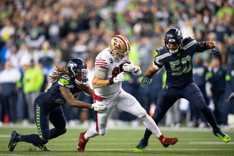 Dec 29, 2019; Seattle, Washington, USA; San Francisco 49ers tight end George Kittle (85) fights off Seattle Seahawks cornerback Shaquill Griffin (26) and Seattle Seahawks outside linebacker K.J. Wright (50) after making a catch during the first half at CenturyLink Field. 