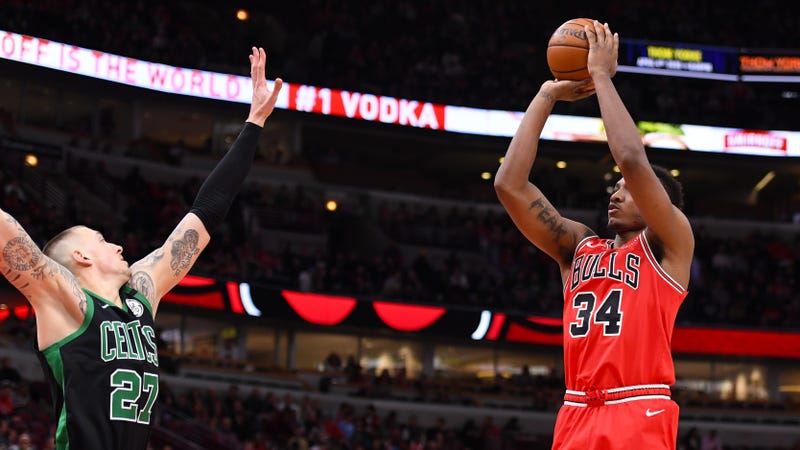 Wendell Carter Jr. takes a jumper over Daniel Theis.