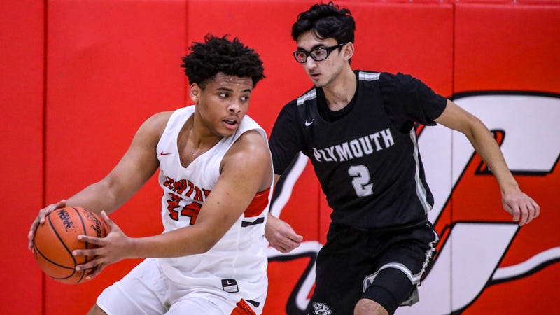 A Canton player goes up against Plymouth's Usman Saiyed. Canton Plymouth Basketball