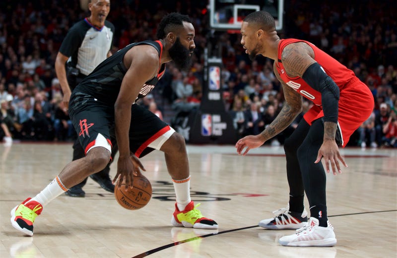 James Harden attempts to dribble past Damian Lillard.