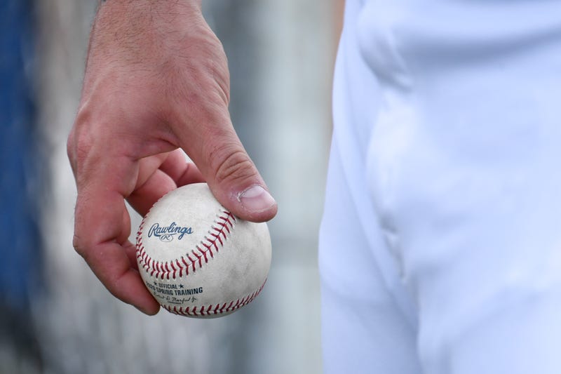 An MLB player holding a baseball.