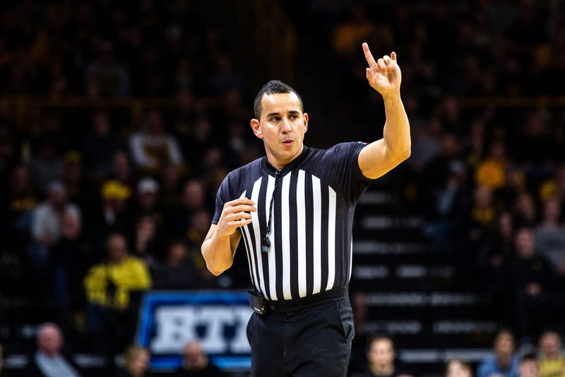 Referee Larry Scirotto gestures during a NCAA Big Ten Conference men's basketball game, 