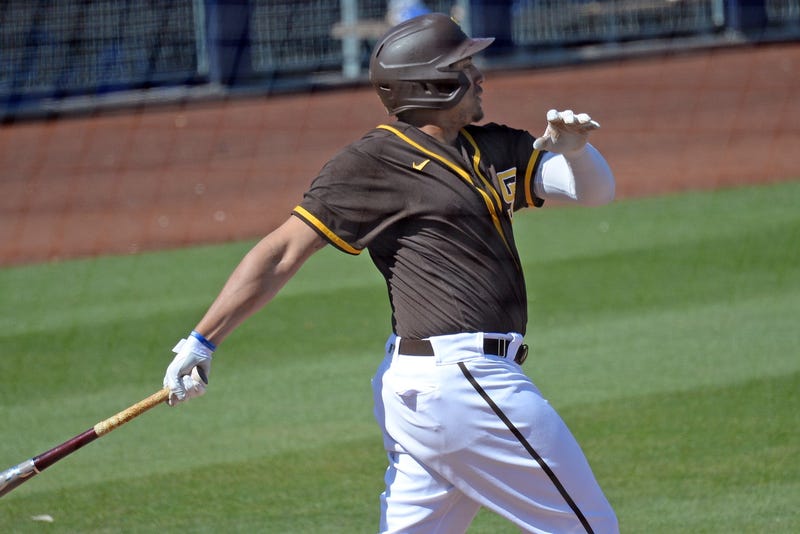 San Diego Padres left fielder Josh Naylor (22) hits a triple against the Los Angeles Dodgers during the third inning of a spring training game at Peoria Stadium.