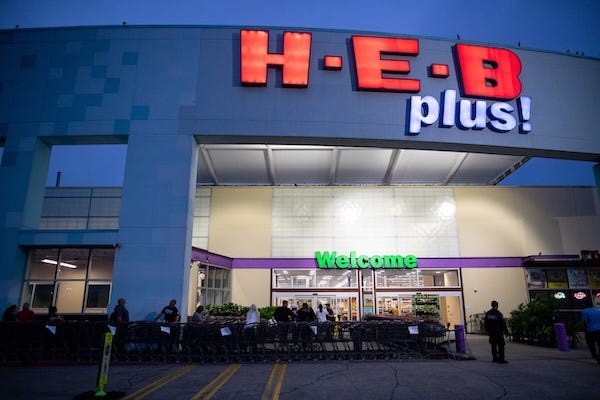 People wait in line at the HEB on Saratoga Boulevard for the store to open at 8am on Sunday, March 15, 2020