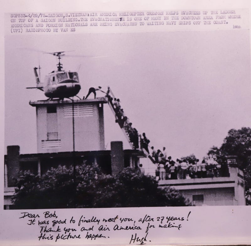 Former Air America pilot Bob Caron has a signed laser photo showing his helicopter evacuating people from a rooftop during the fall of Saigon , April 29, 1975.