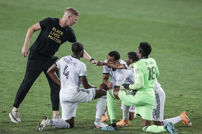 Philadelphia Union head coach Jim Curtin fist bumps defender Ray Gaddis (28) in front of goalkeeper Andre Blake (18) and defender Mark McKenzie (4) during the second half at Red Bull Arena.