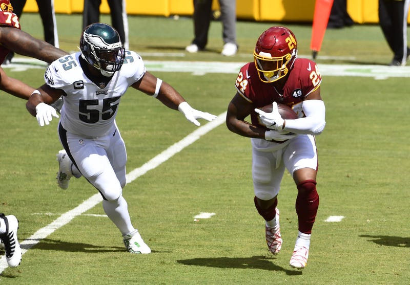 Washington Football Team running back Antonio Gibson (24) carries the ball as Philadelphia Eagles defensive end Brandon Graham (55) chases