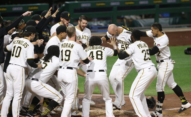 Pittsburgh Pirates teammates mob catcher Jacob Stallings (58) at home plate after he hit a game winning walk off solo home
