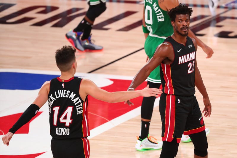 Miami Heat guard Tyler Herro (14) reacts with forward Jimmy Butler (22)