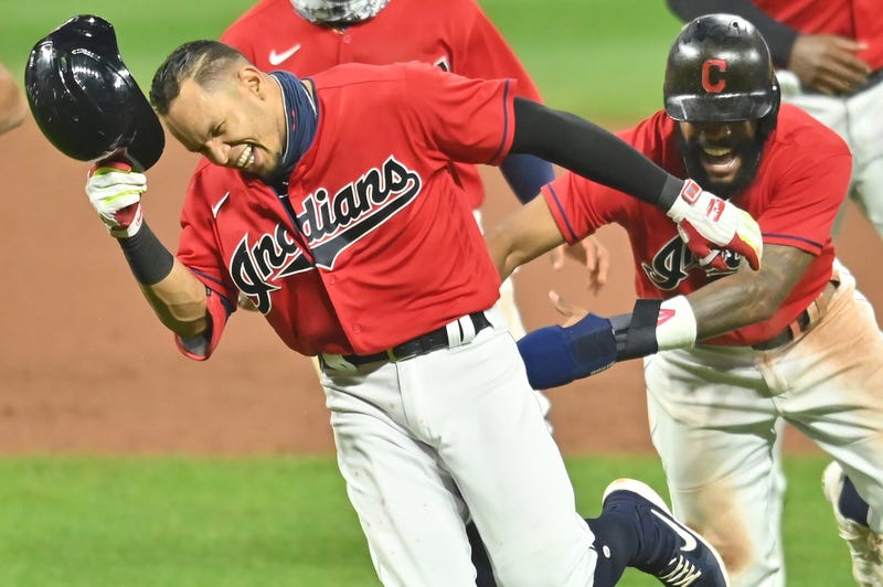 Cleveland Indians center fielder Delino DeShields (0) chases second baseman Cesar Hernandez (7) after Hernandez won the game with an RBI single during the ninth inning against the Pittsburgh Pirates at Progressive Field.