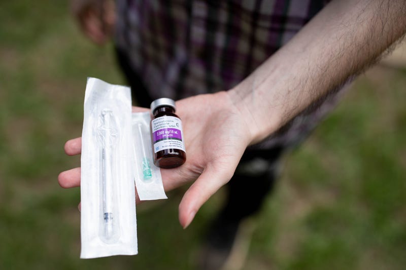 Jay Galante holds a bottle of the testosterone he is prescribed to take by his Planned Parenthood healthcare provider for his gender transition along with the needle he uses to inject it.