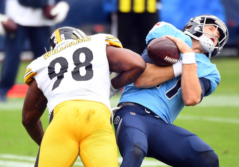 Tennessee Titans quarterback Ryan Tannehill (17) is hit by Pittsburgh Steelers inside linebacker Vince Williams (98)