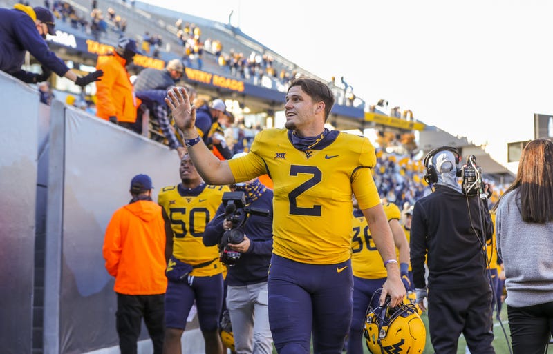 WVU players with fans at home