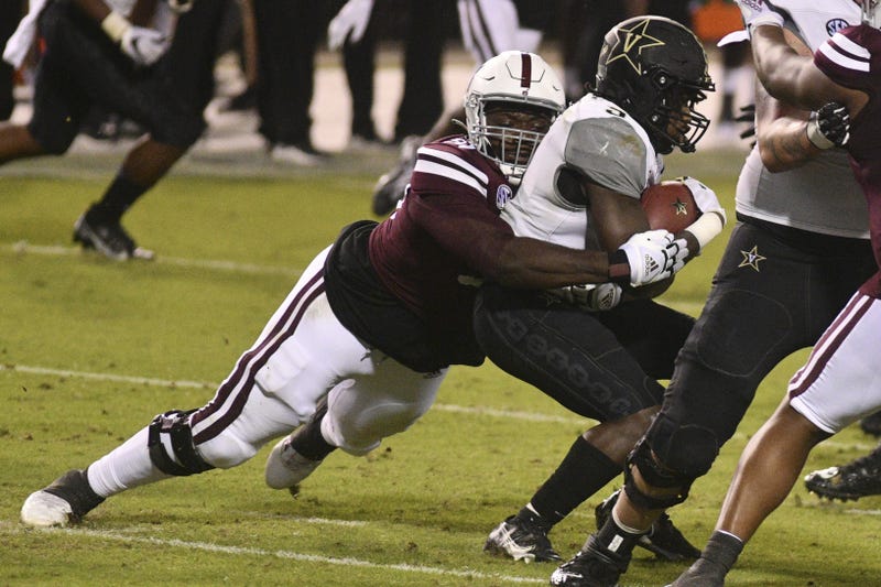 Mississippi State Bulldogs defensive tackle Cameron Young (L) tackles Vanderbilt Commodores running back Rocko Griffin (9) during the fourth quarter at Davis Wade Stadium at Scott Field.