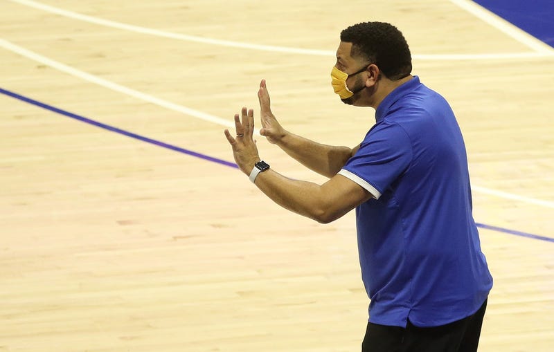 Jeff Capel with mask on and hands out
