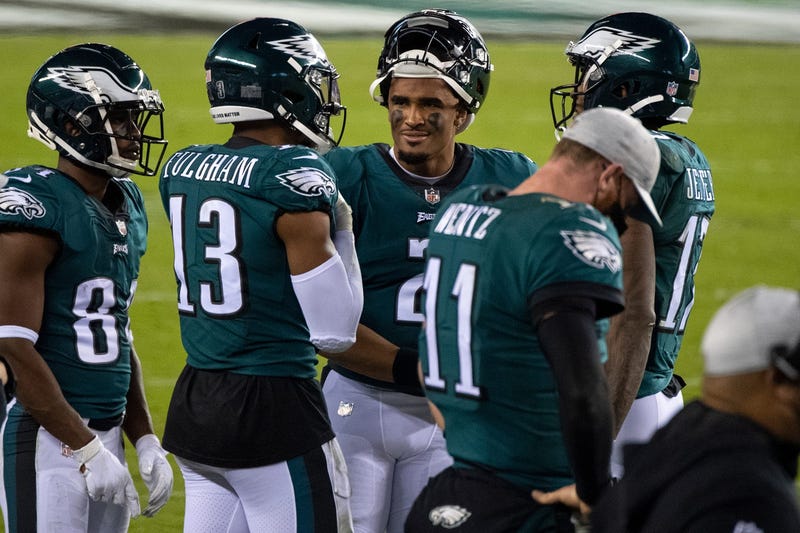 Eagles' Jalen Hurts (2) speaks with teammates on the sideline late in fourth quarter trailing the Seahawks Monday, Nov. 30, 2020.