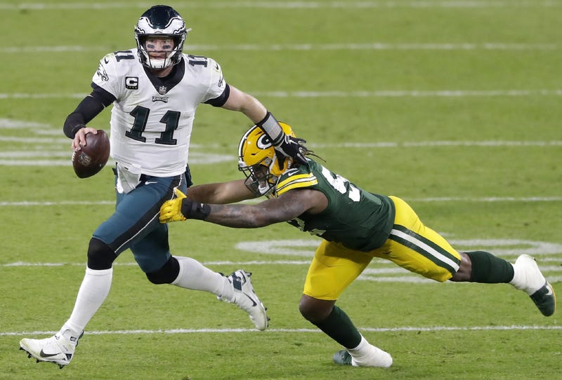 Green Bay Packers linebacker Rashan Gary (52) chases Philadelphia Eagles quarterback Carson Wentz (11)