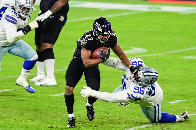 Ravens RB JK Dobbins stiff-arms Neville Gallimore during Tuesday night's Ravens victory over Dallas