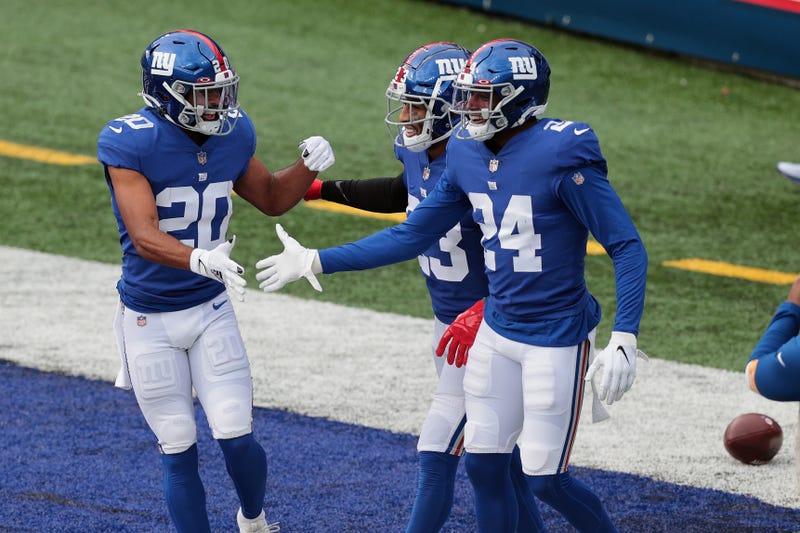 New York Giants cornerback James Bradberry (24) celebrates with cornerback Julian Love (20) and cornerback Logan Ryan (23) after breaking up a pass against the Arizona Cardinals during the first half at MetLife Stadium.
