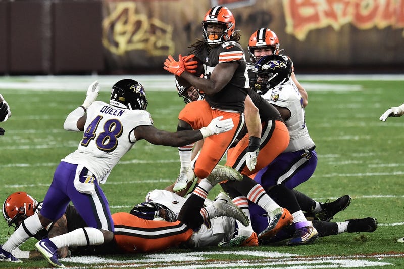 Cleveland Browns running back Kareem Hunt (27) runs with the ball as Baltimore Ravens inside linebacker Patrick Queen (48) defends during the second half at FirstEnergy Stadium.