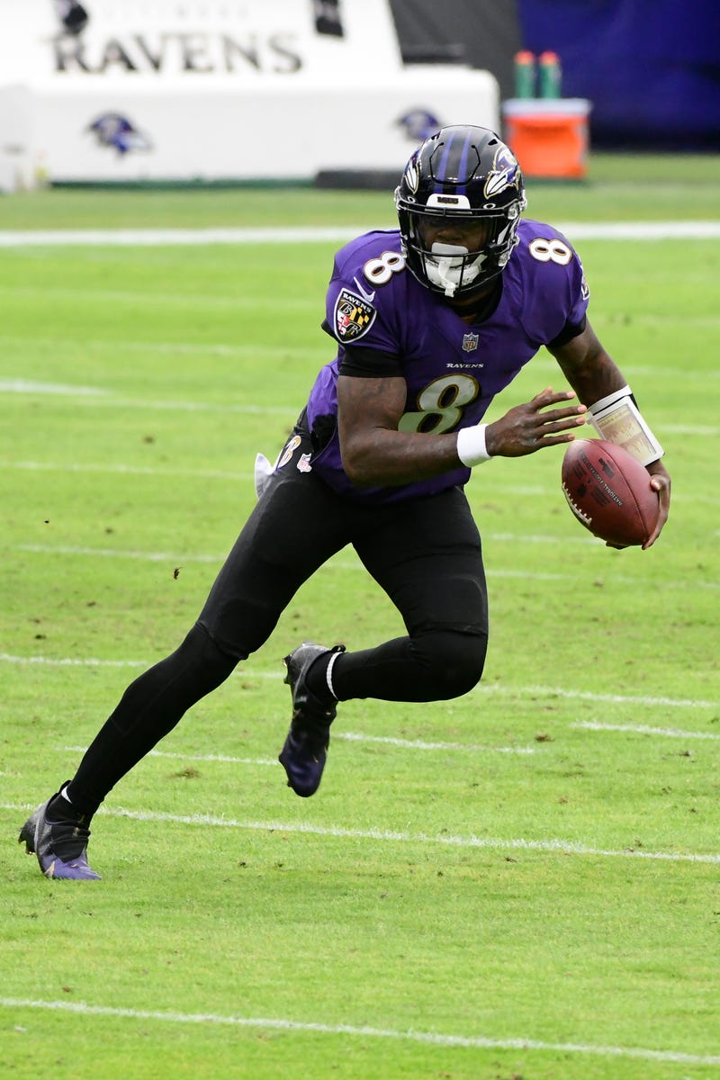 Lamar Jackson eludes defenders during Baltimore's 40-14 win over the Jaguars.