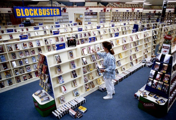 Lisa Morse, assistant manager of the new Blockbuster Video store in the City Square shopping center in Hendersonville, Tenn., stocks shelves in the comedy section Dec. 12, 1990