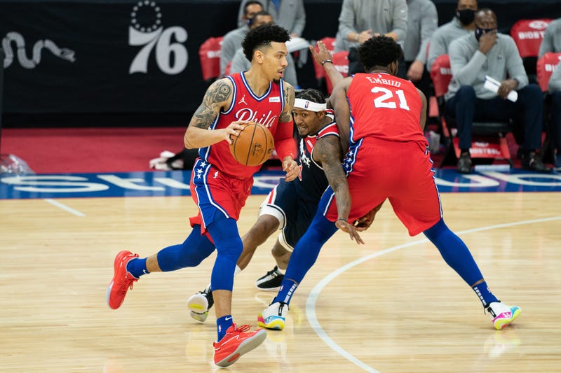 Philadelphia 76ers guard Danny Green (14) dribbles past Washington Wizards guard Bradley Beal (3) and center Joel Embiid (21) during the third quarter at Wells Fargo Center.