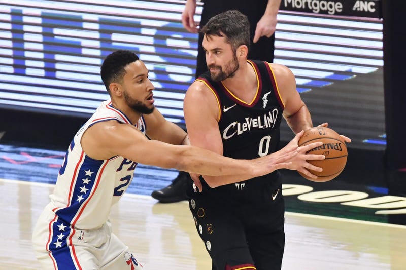 Dec 27, 2020; Cleveland, Ohio, USA; Philadelphia 76ers guard Ben Simmons (25) defends Cleveland Cavaliers forward Kevin Love (0) during the first quarter at Rocket Mortgage FieldHouse.