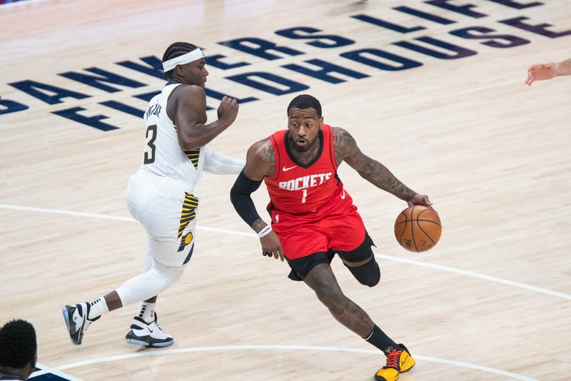 Houston Rockets guard John Wall (1) dribbles the ball while Indiana Pacers guard Aaron Holiday (3) defends in the third quarter at Bankers Life Fieldhouse.