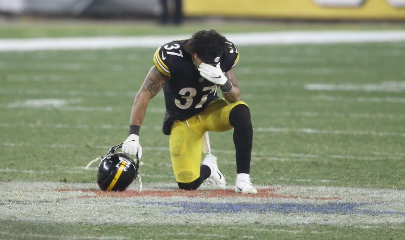 safety Jordan Dangerfield (37) kneels on the midfield logo after the AFC Wild Card playoff game