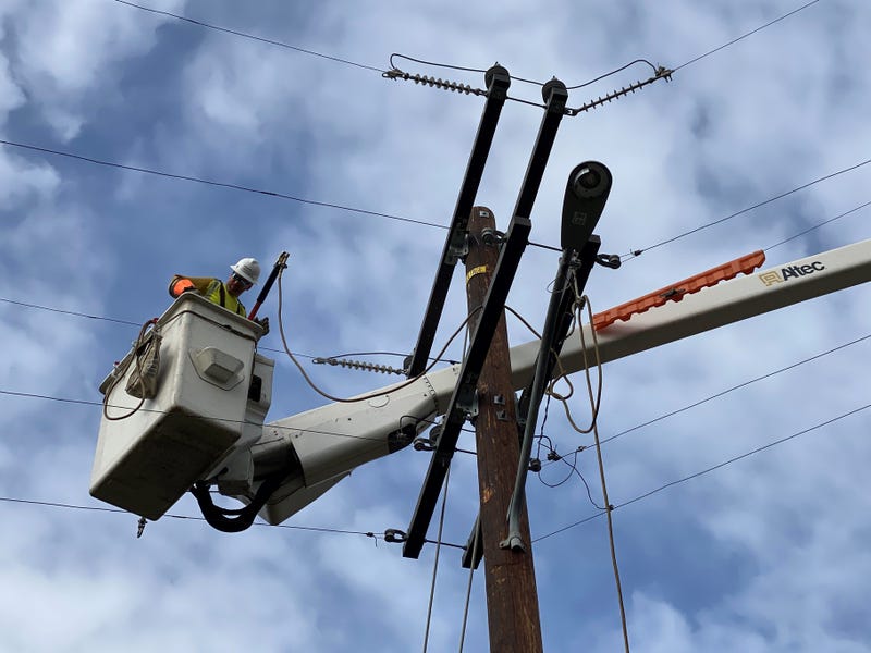 A Southern California Edison contractor works on power lines.