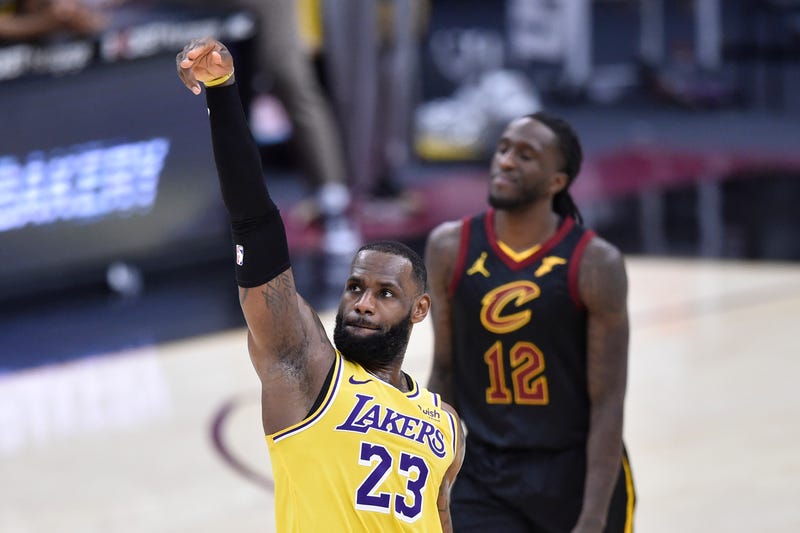 Jan 25, 2021; Cleveland, Ohio, USA; Cleveland Cavaliers forward Taurean Prince (12) reacts as Los Angeles Lakers forward LeBron James (23) makes a three-point basket in the fourth quarter at Rocket Mortgage FieldHouse.