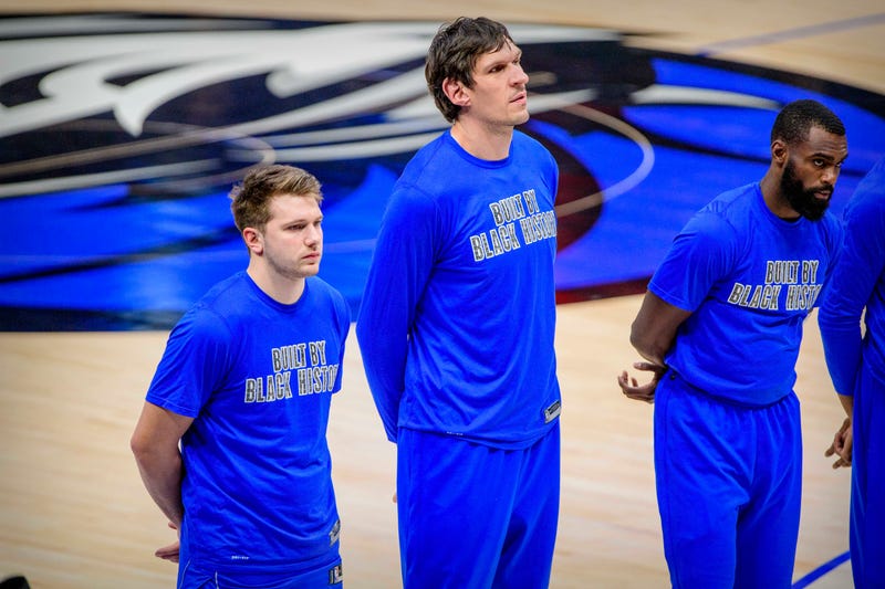 Dallas Mavericks players stand during the national anthem