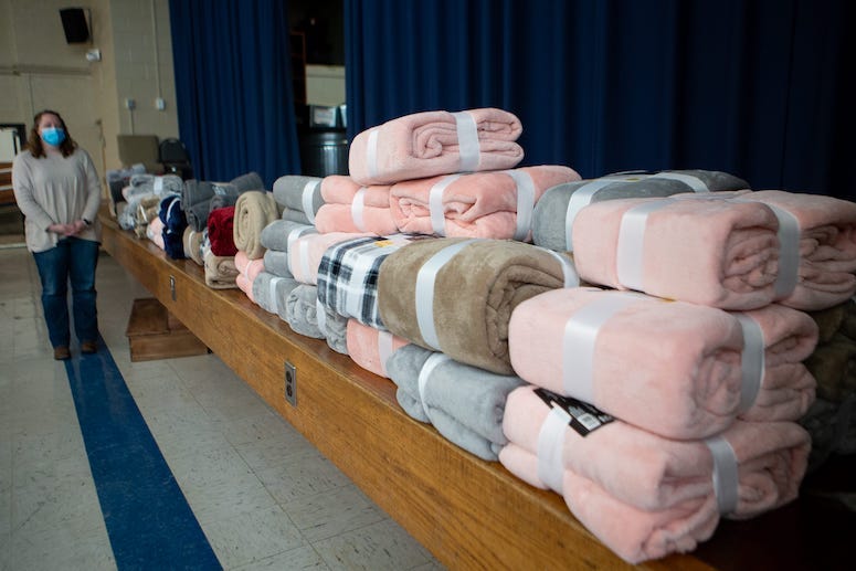 Warming center, pile of fleece blankets